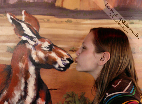 Caitlin kissing a wall painting steakhouse photo trickery Leanne Wildermuth